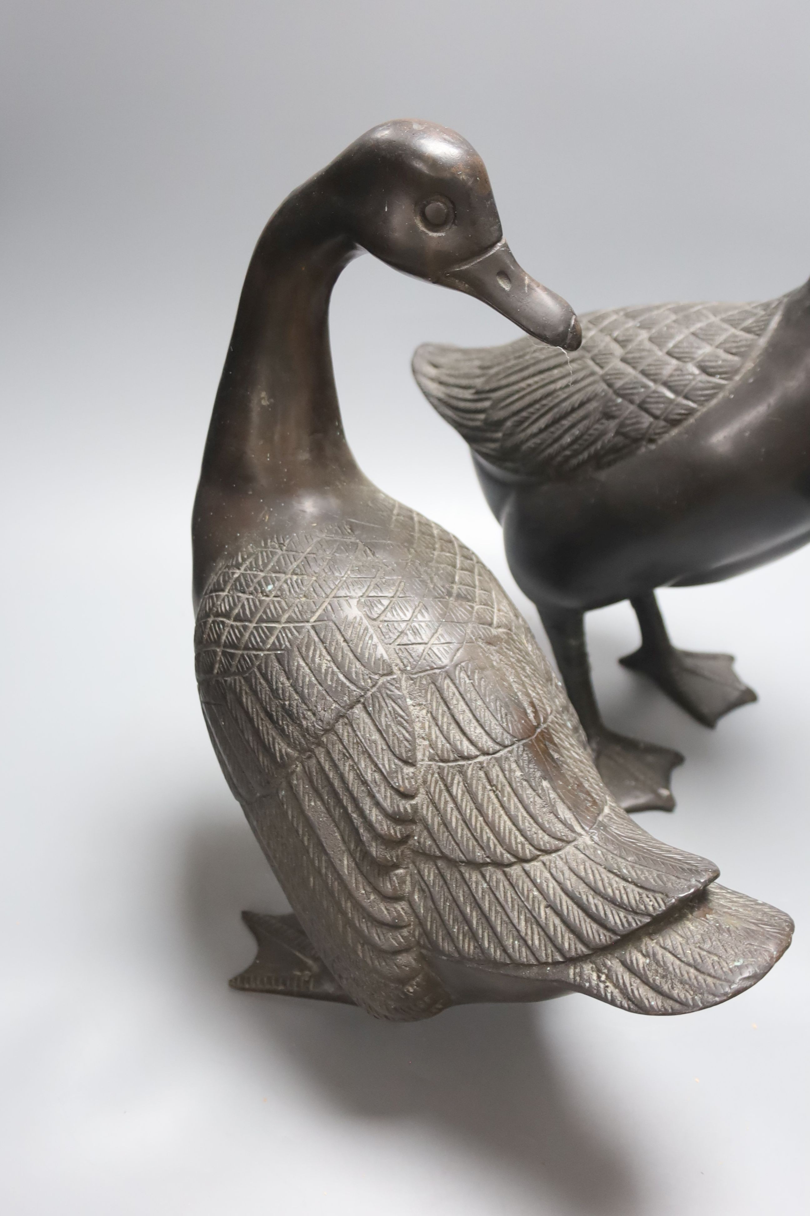 A pair of modern Chinese bronze models of geese, largest 48cm